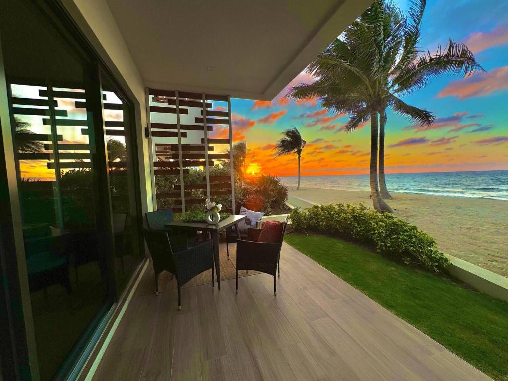 a dining room with a view of the beach at Oceanfront Residency luxury 2B2B ,1-6 person ,terrasse, beach access garden pool in Old Man Bay