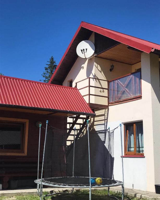 a house with a sign on the side of it at Під зорями in Slavske