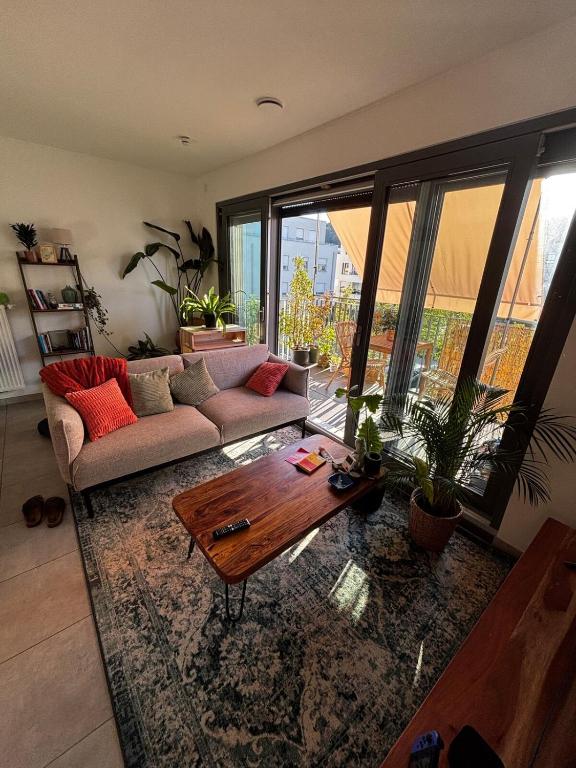 a living room with a couch and a coffee table at Cozy personal flat in Differdange in Differdange