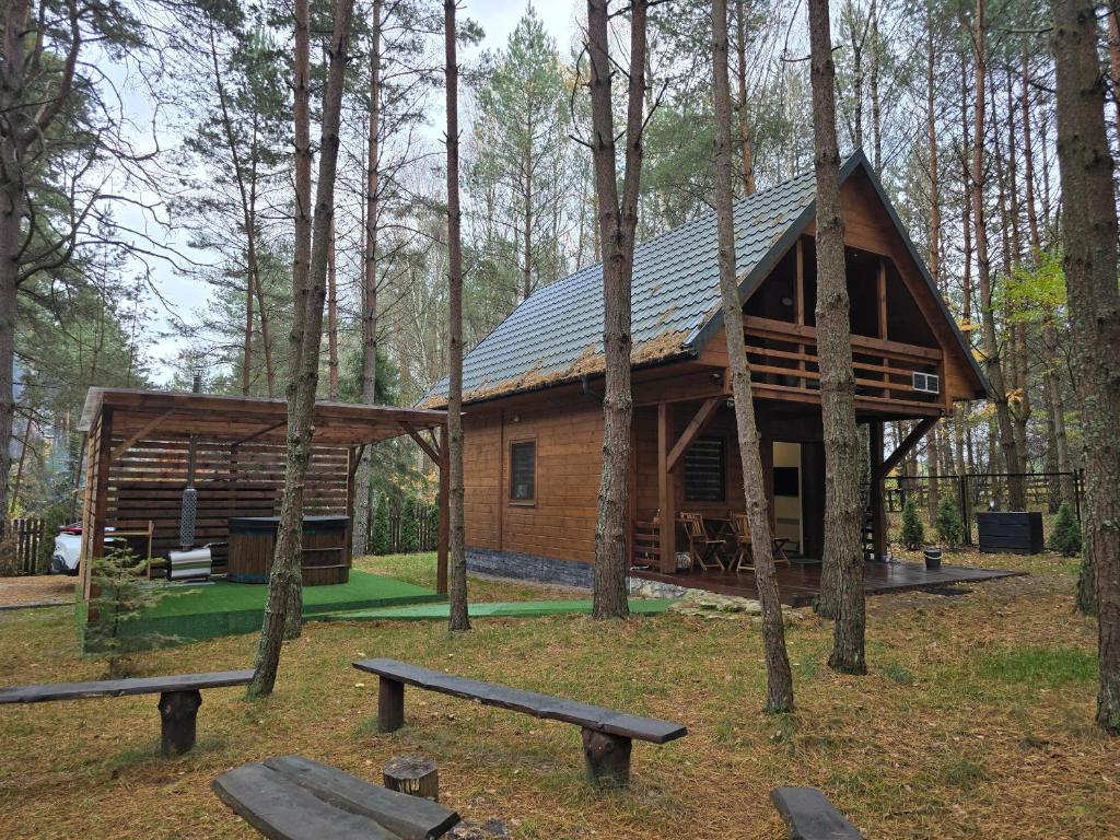 a log cabin in the middle of the forest at Lesna Kryjowka Roztocze in Rybnica