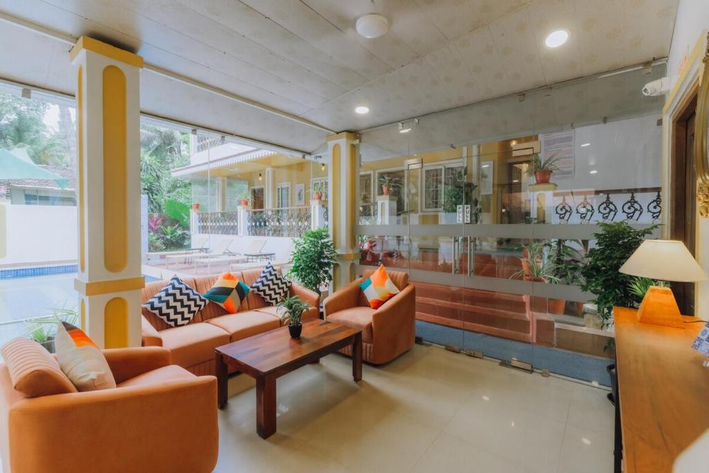 a living room with couches and a coffee table at Pvt Pool - Villa Azura Escape Marialina Calangute in Saligao