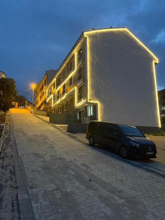a van parked in front of a building at Royal Suit in Bandırma