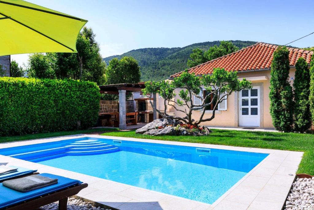 a swimming pool in the backyard of a house at Sele by Vintage Travel in Gruda