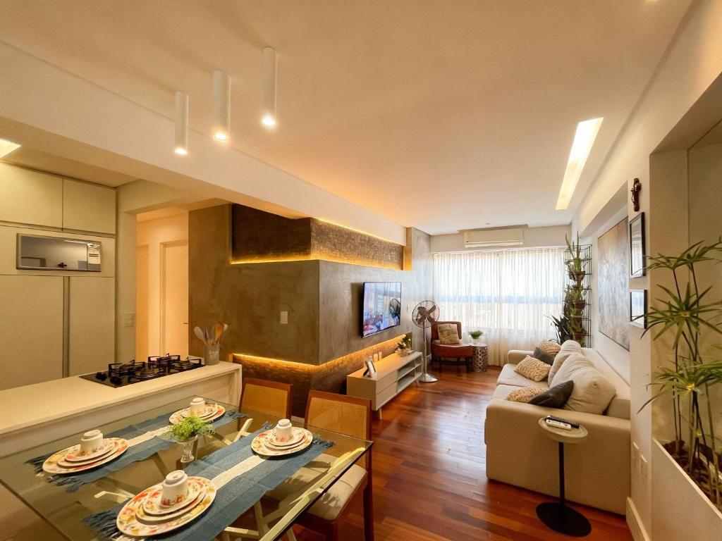 a living room with a couch and a table at Brisas do Cabo Branco by Hosppedar in Tambaú