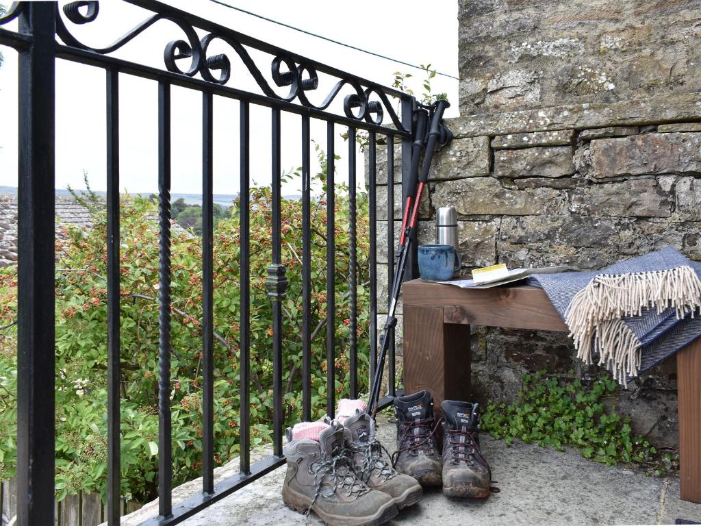 a group of boots sitting next to a iron fence at The Owlery At Aysgarth in Aysgarth