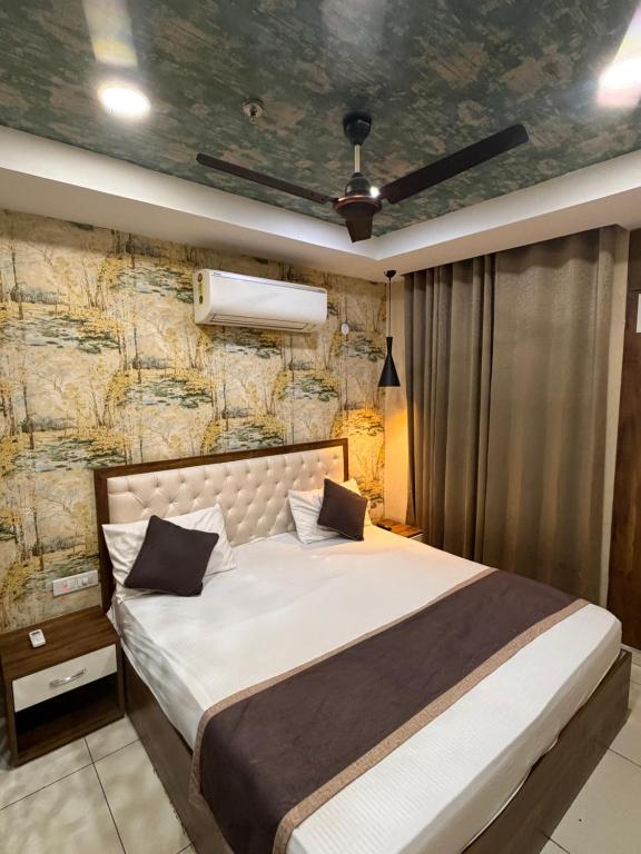 a bedroom with a large bed with a stone wall at The Cove in Zirakpur