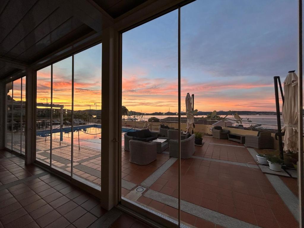 a view of a sunset from the balcony of a house at Hotel Miralonga in La Maddalena