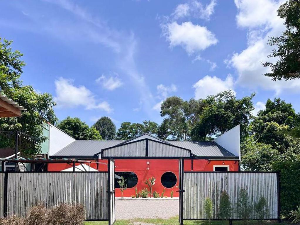 een rode schuur met een hek ervoor bij 7Sea Beach Pool Villa in Ao Nam Mao