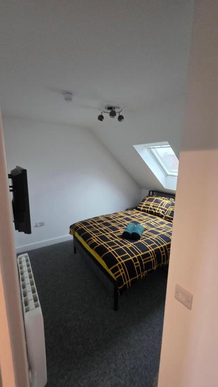 a bedroom with a bed and a tv in a room at Studio apartment in Fishponds in Bristol