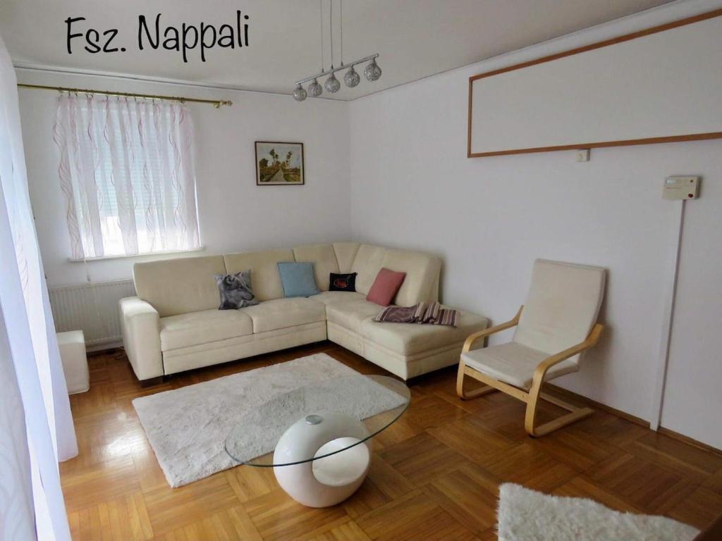 a living room with a couch and a chair at Rosental Privatunterkunft in Sankt Margareten im Rosental