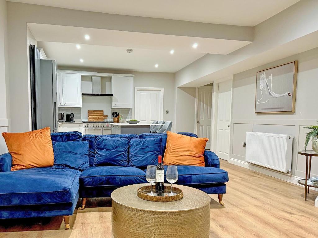 a living room with a blue couch and a table at Stone's Throw in Richmond