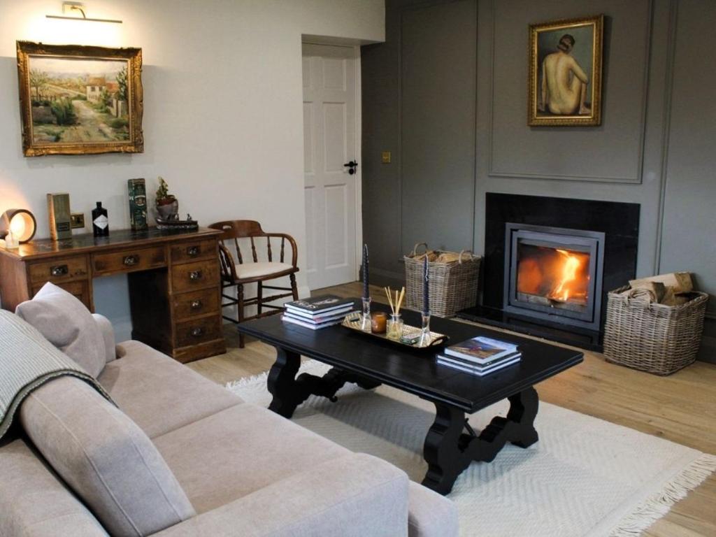 a living room with a coffee table and a fireplace at Willow Lodge Cashel- Rock View-Sleeps 8 guests-Spacious- Cosy in Cashel