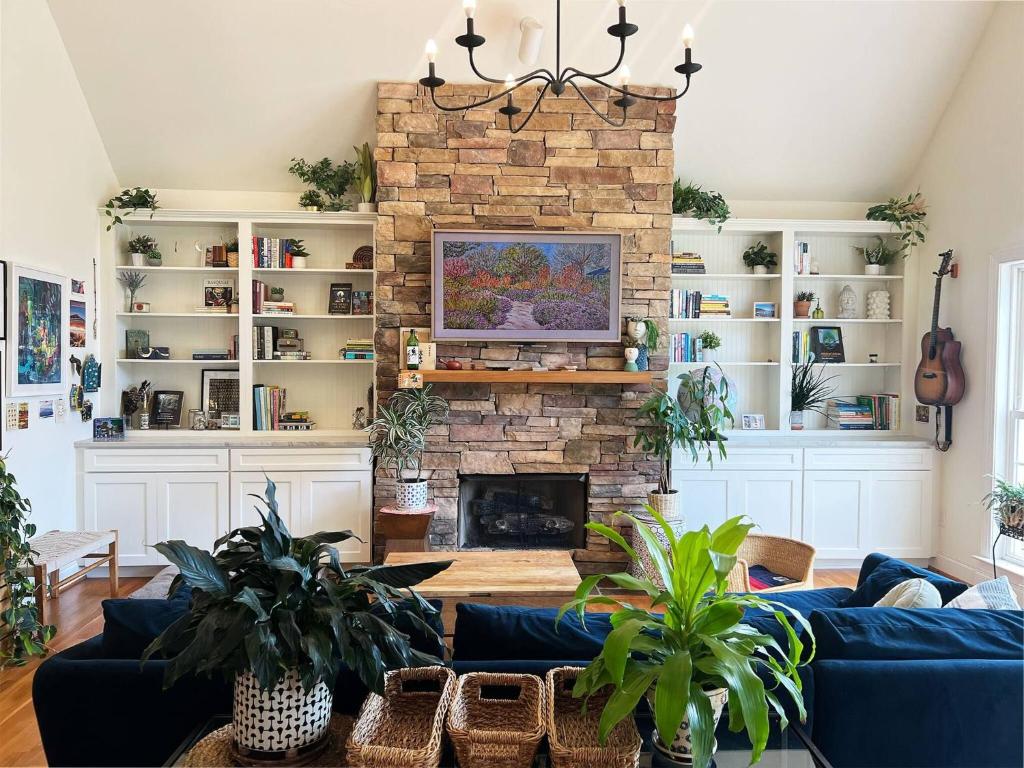 a living room with a blue couch and a fireplace at Peaceful 3BR on 5 acres - Minutes from Nashville in Joelton