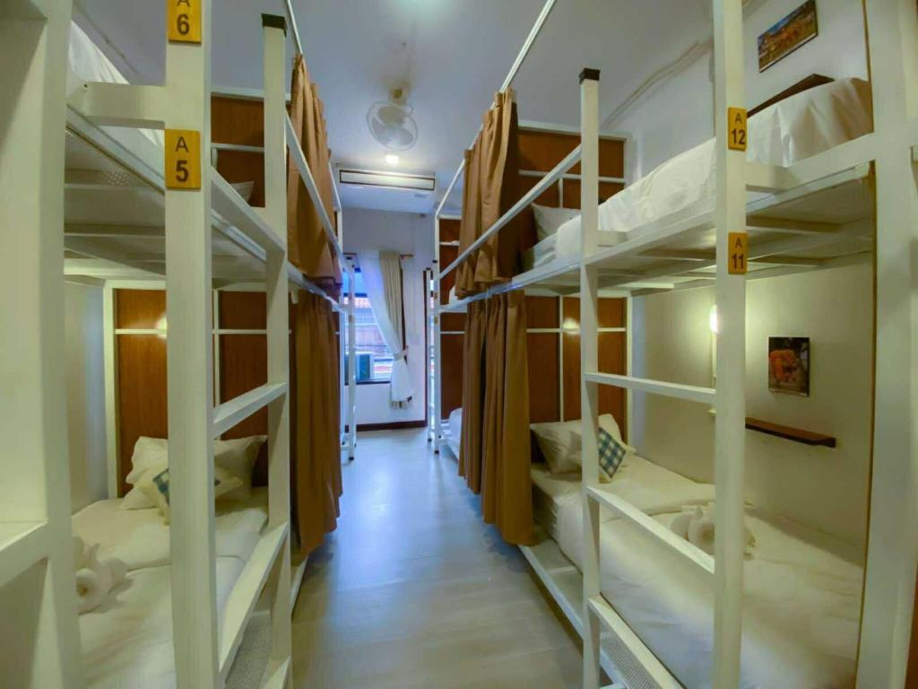 a hallway with four bunk beds in a room at Sanga Rooftop Hostel in Pakse