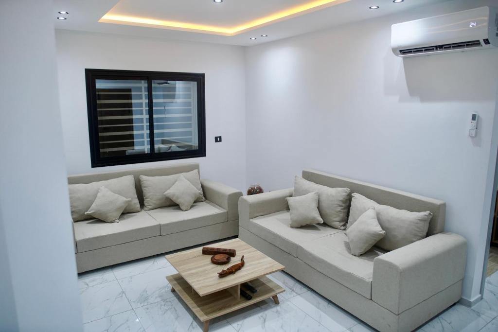 a living room with two couches and a coffee table at Résidence Sana in Mahdia