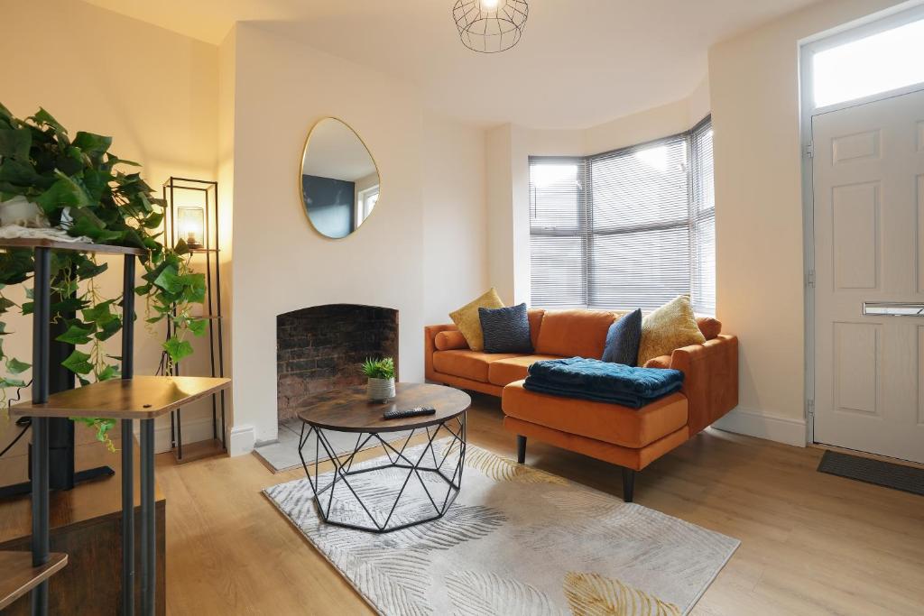 a living room with a couch and a fireplace at 3-Bed Home Perfect for Exploring Nottingham & Derby in Long Eaton