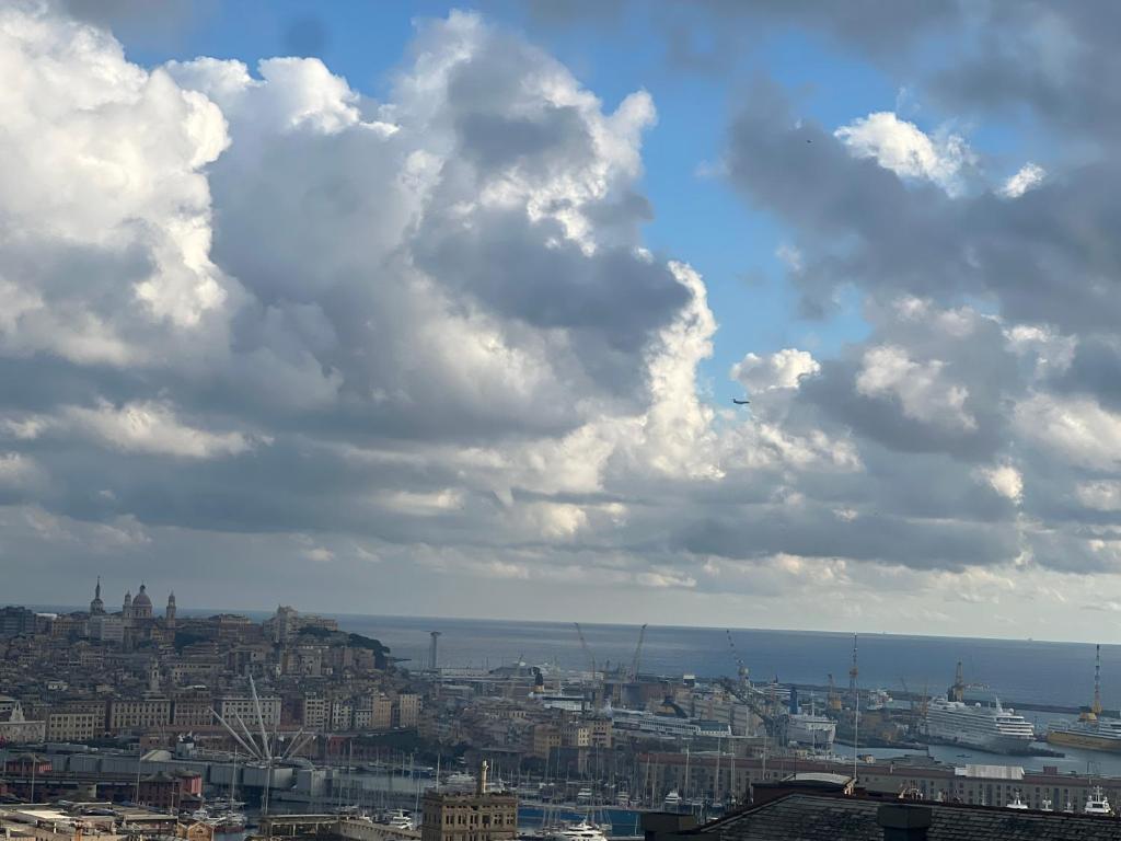 a view of a city under a cloudy sky at Angelo Home in Genova