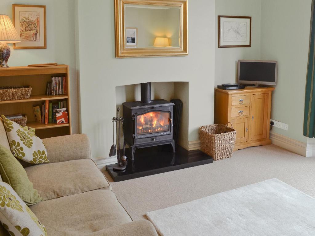 a living room with a wood stove in a living room at Hillcrest in Pickering