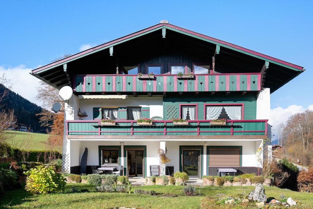 a house with a balcony on top of it at Haus am See - Wohnung Königssee in Königssee