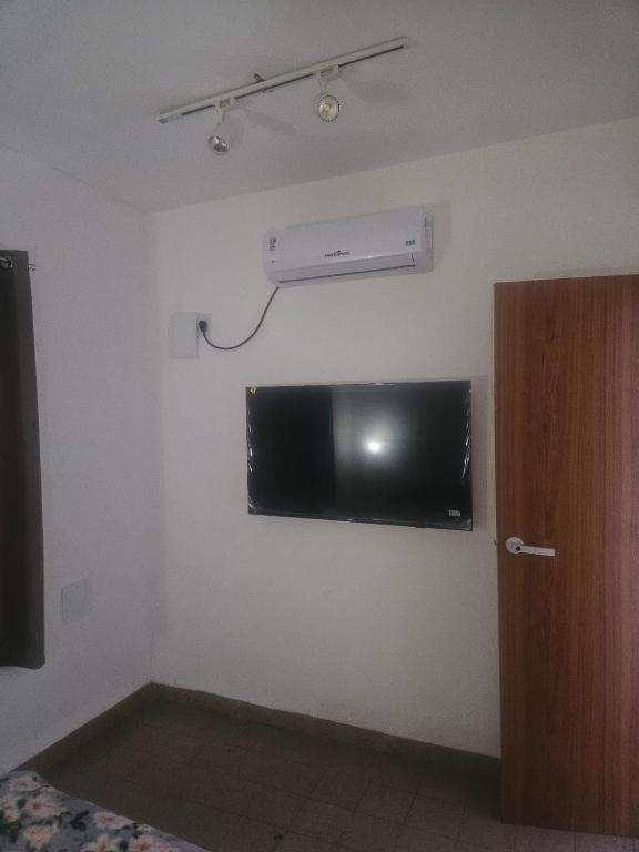 a room with a flat screen tv on the wall at Pousada Gaturama Village in Corumbá