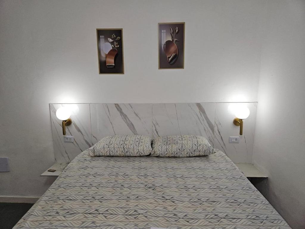 a bedroom with a bed with two pillows on it at Pousada Gaturama Village in Corumbá