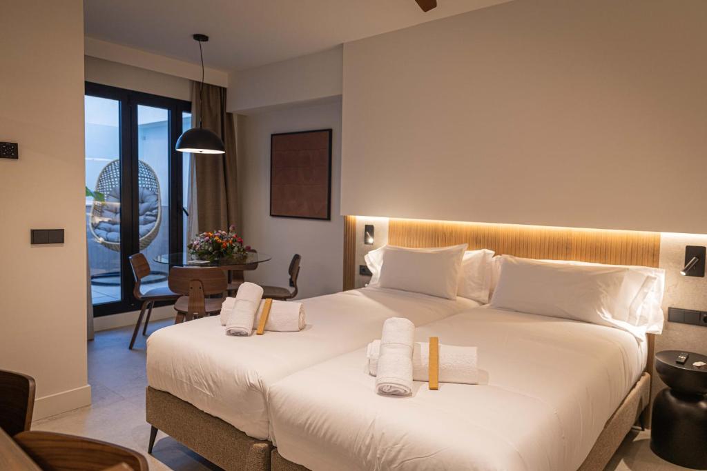 a hotel room with a bed with towels on it at Moontels Colón in Valencia