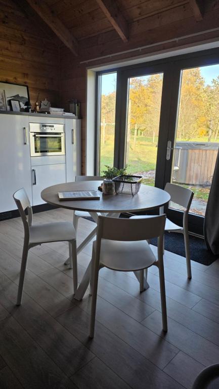 a kitchen with a table and chairs in a room at Lodge Klein Ganseij in Olst