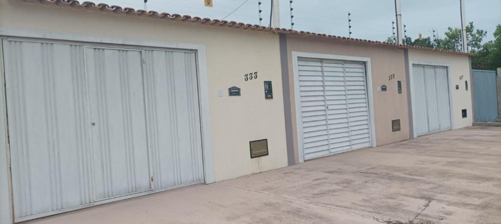 a row of white garage doors on a building at Casa Mar in Prado