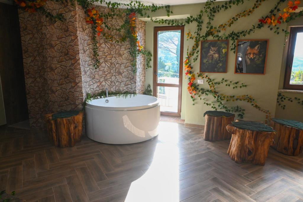 a bathroom with a bath tub and some logs at B&B Borgo Sciugolo in Baselice