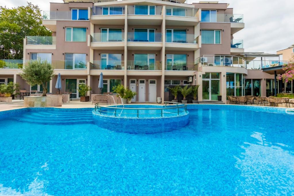 a large swimming pool in front of a building at Selena Beach Family Hotel - All Inclusive Light in Sozopol