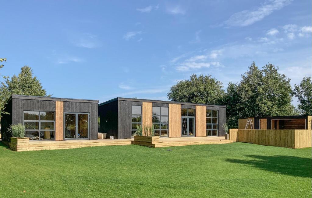 a modern house with a large yard at Awesome Home In Vinderup With Sauna in Vinderup
