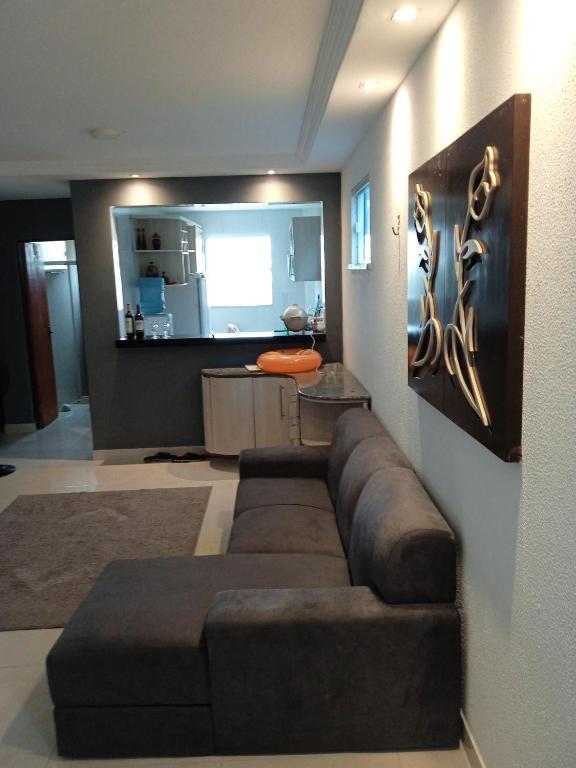 a living room with a brown couch in a room at Condomínio tropicaliente in Caucaia