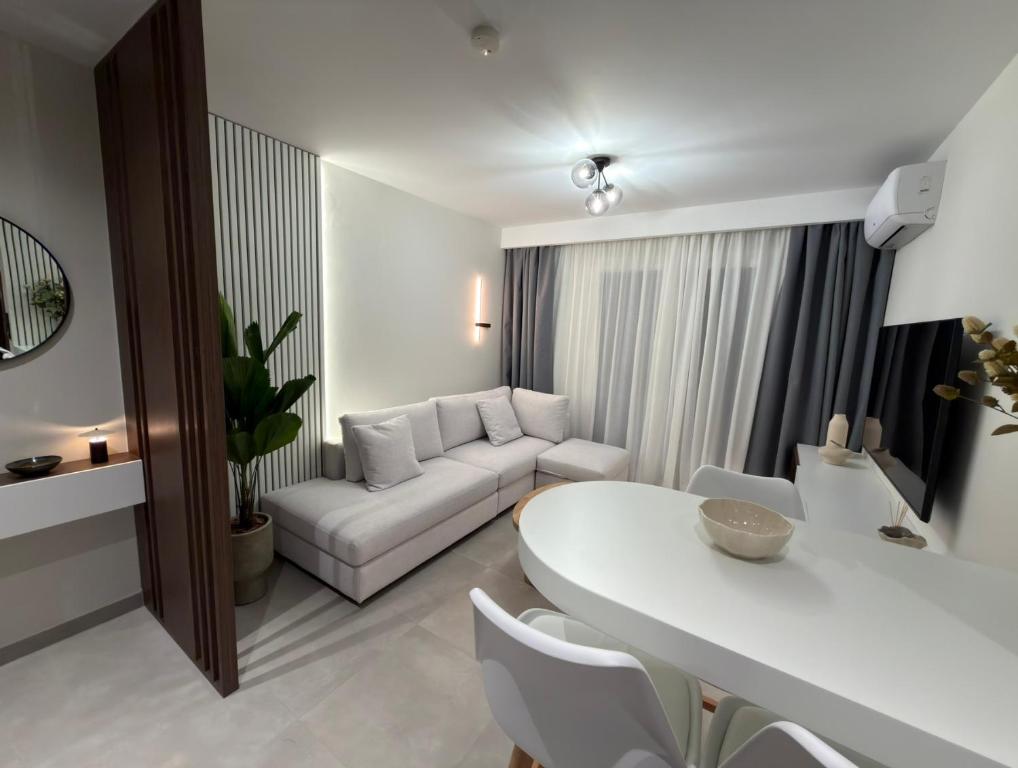 a living room with a white table and a couch at Nexa Suite in Komotini