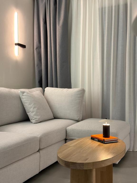 a living room with a couch and a candle on a table at Nexa Suite in Komotini