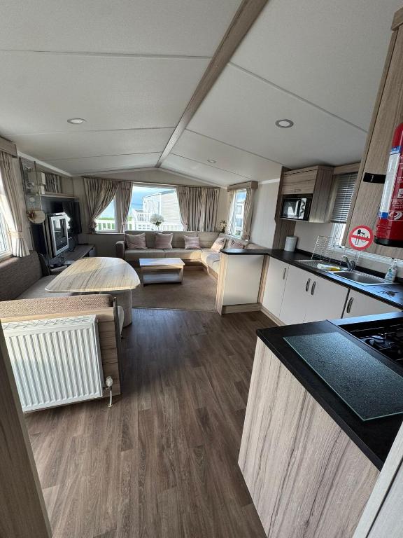 a kitchen and living room of a caravan at Luxury Seafront 3 Bedroom Caravan in Minishant