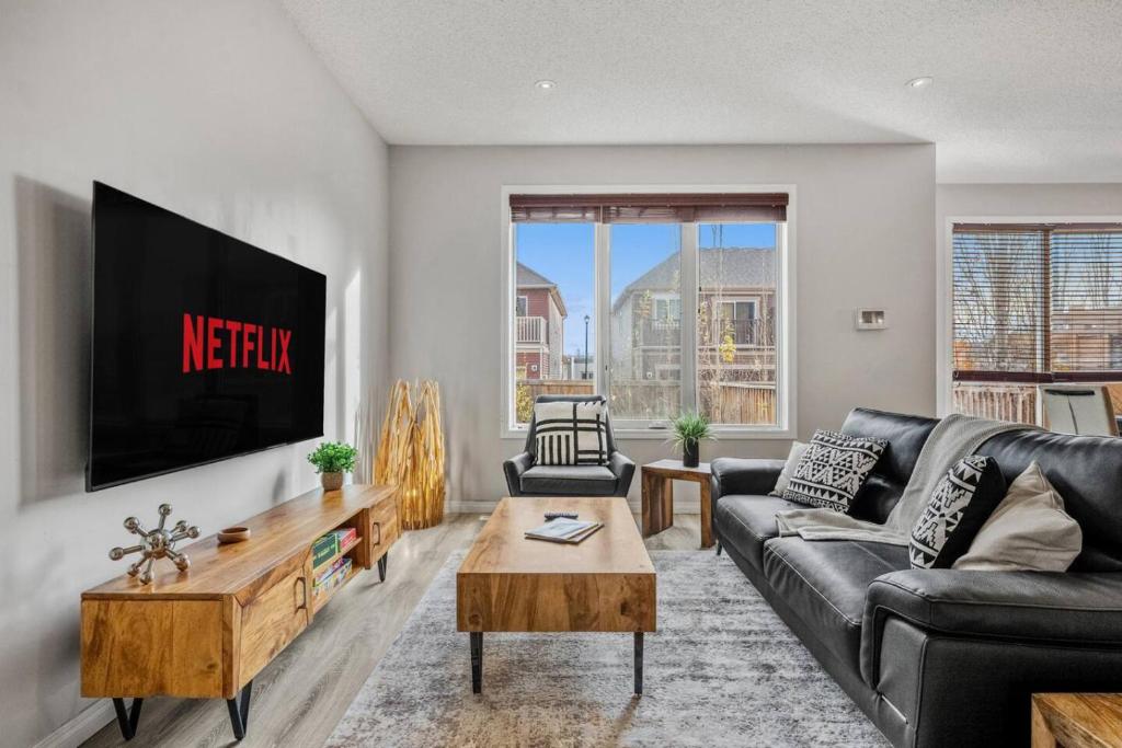 a living room with a couch and a tv at Single 3 Bedroom Full Private House in Airdrie