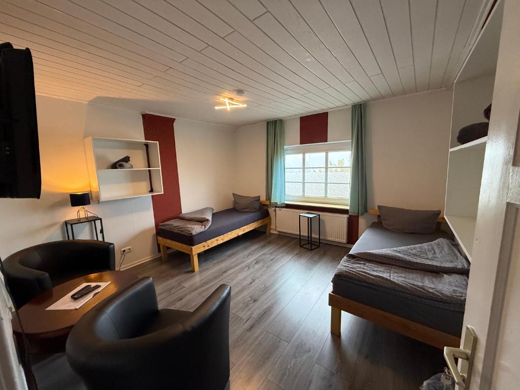 a room with a bed and a couch and a table at Zimmer 3 in Bullendorf