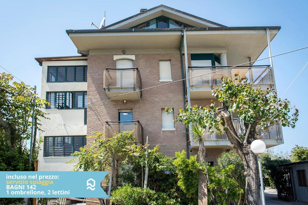 an apartment building with trees in front of it at Appartamento a Senigallia in Lungomare Da Vinci - SE006 in Senigallia