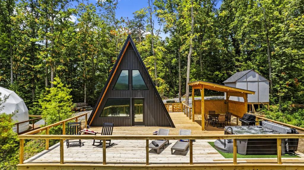 a house shaped like a triangle on a wooden deck at Modern A-Frame Cabin with Breathtaking Views of the Smoky Mountains, Perfect for Families or Groups in Hartford