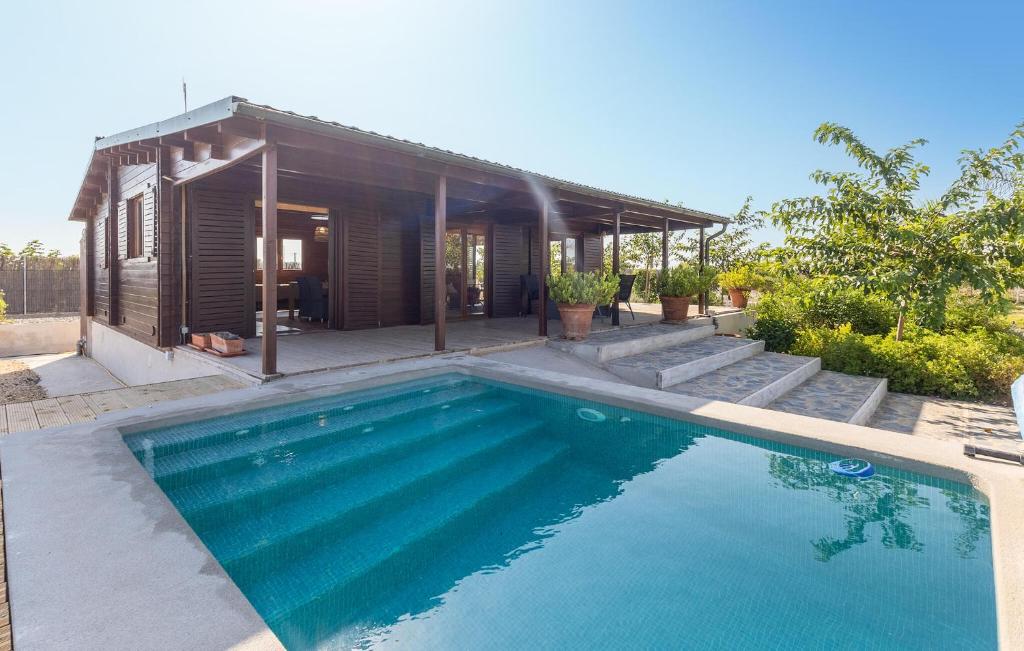 a swimming pool in front of a house at Beautiful Home In Guardamar Del Segura in El Camino de Catral