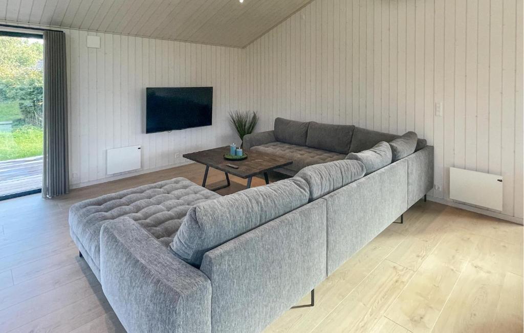 a living room with a couch and a table at Amazing Home In Sjællands Odde With Sauna in Yderby