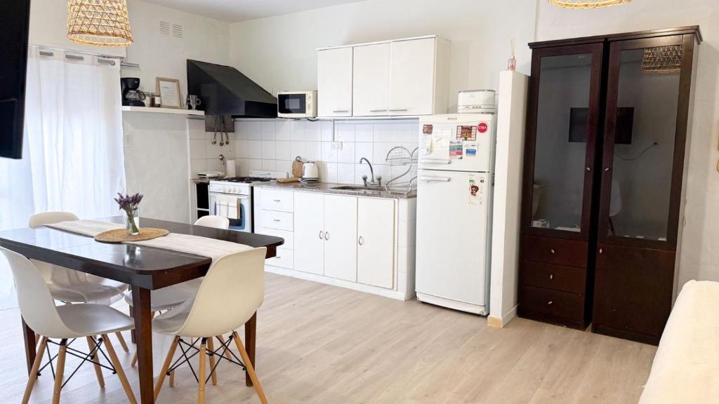 グアレグアイチュにあるDpto Costanera Gualeguaychu Alemのテーブルと白い冷蔵庫のあるキッチン