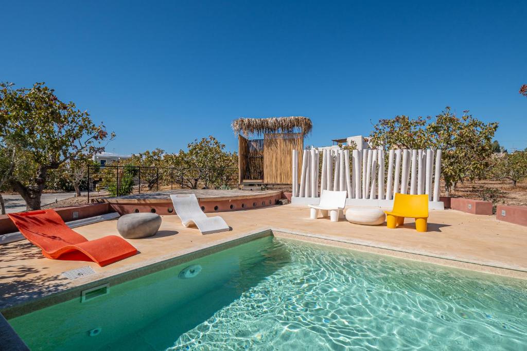a swimming pool with chairs and a pool of water at Villa Faros in Egina