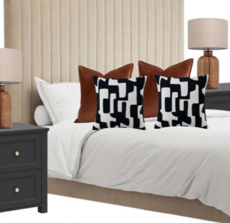 a bedroom with a bed with black and white pillows at Gorgeous Town Centre 3-Bed 2-Bath Apartment Parking Available in Harrogate