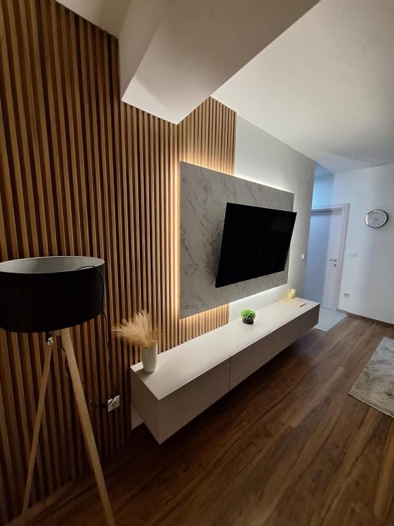 a living room with a flat screen tv on a wall at Premium Central Skopje Apartments & Free Private Parking in Skopje