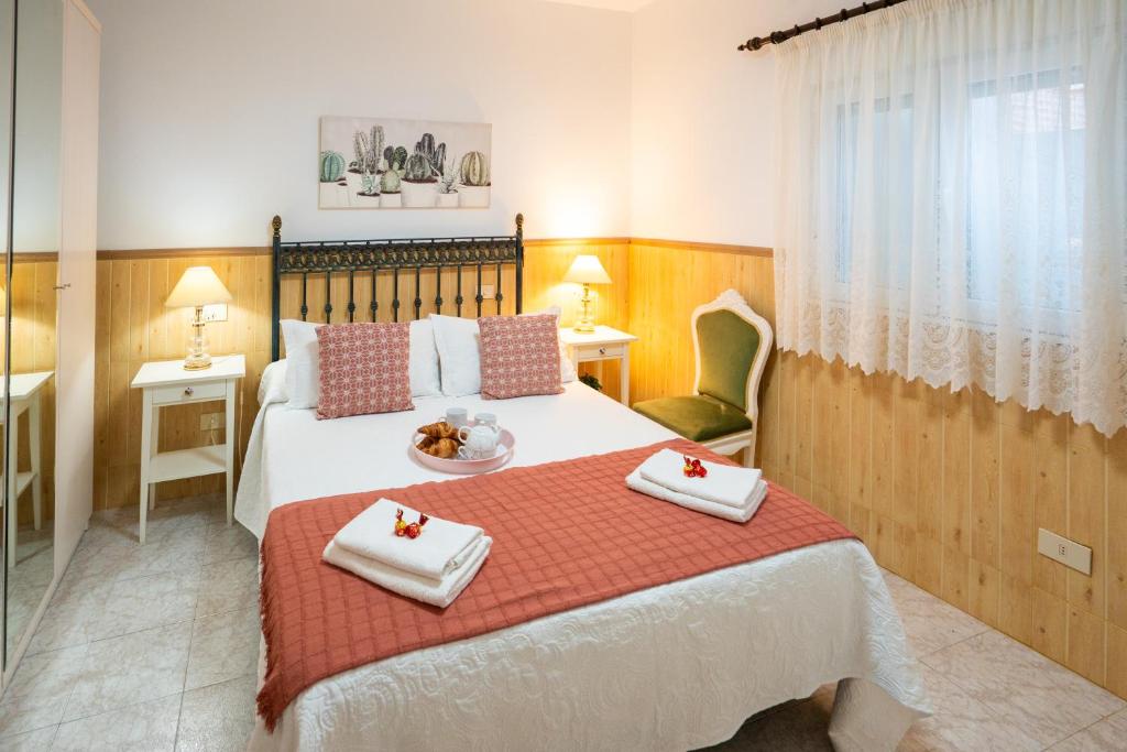 a bedroom with a bed with two towels on it at Ocean views "Las Garzas" in Sardina