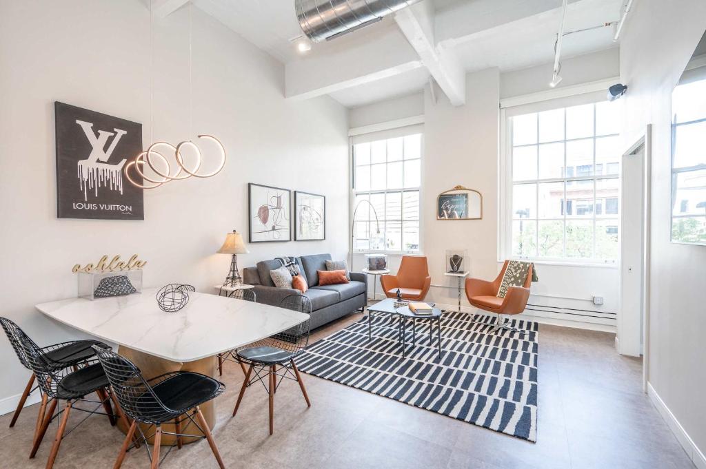 a living room with a table and chairs at The 333 Suites 301 - Suite for 6 in Cincinnati