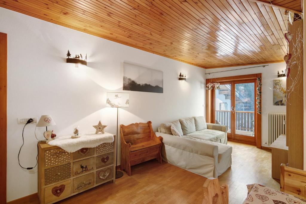 a living room with white walls and a wooden ceiling at Matteo's apartment by Alpenwhite in Livigno