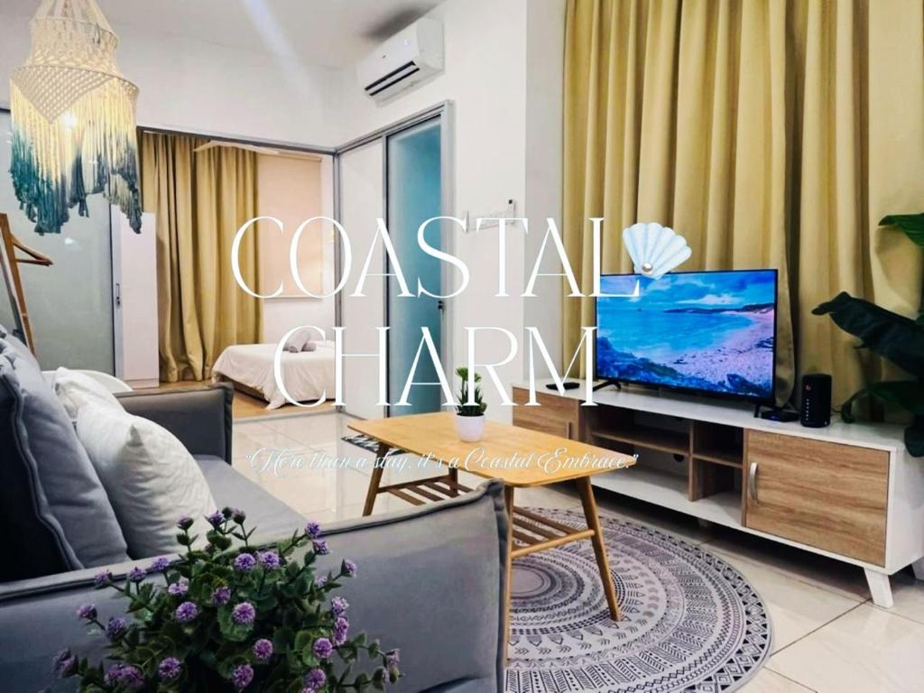 a living room with a couch and a tv at ITCC Manhattan Suites By Coastal Charm in Penampang