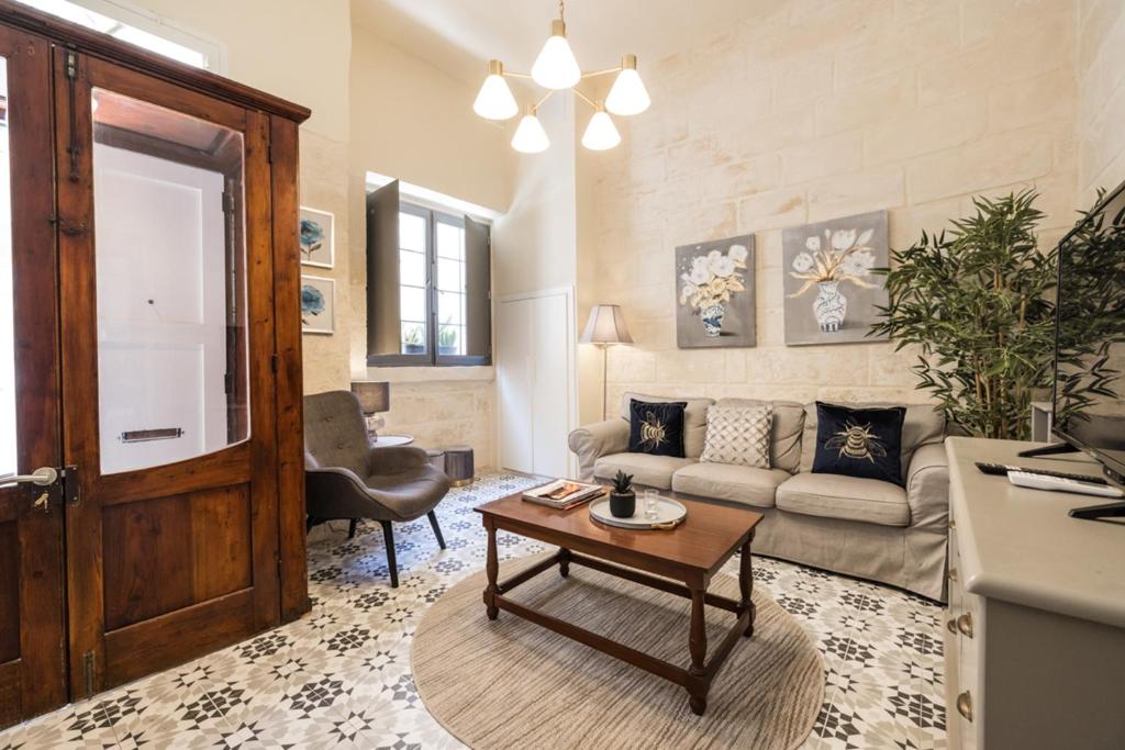 a living room with a couch and a table at Birgu 3 in Cospicua